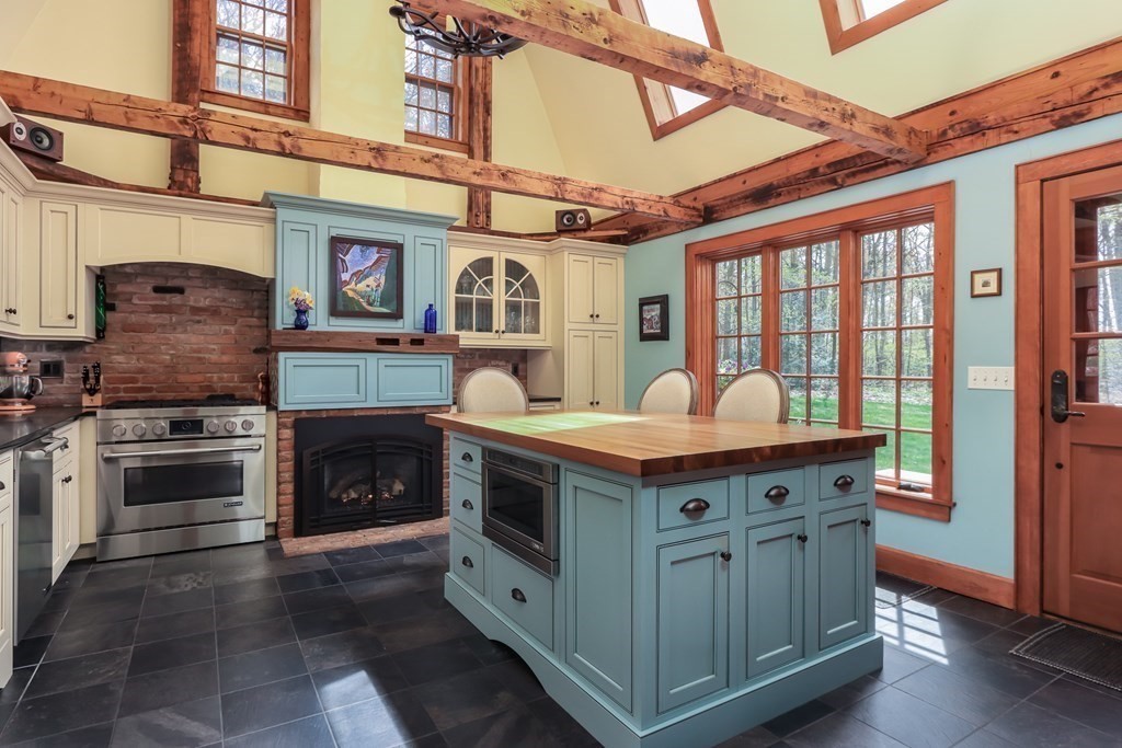 24 Whitney Road Shirley, MA 01464 - Photo 3 of 42 a utility room with stainless steel appliances granite countertop a stove and a refrigerator