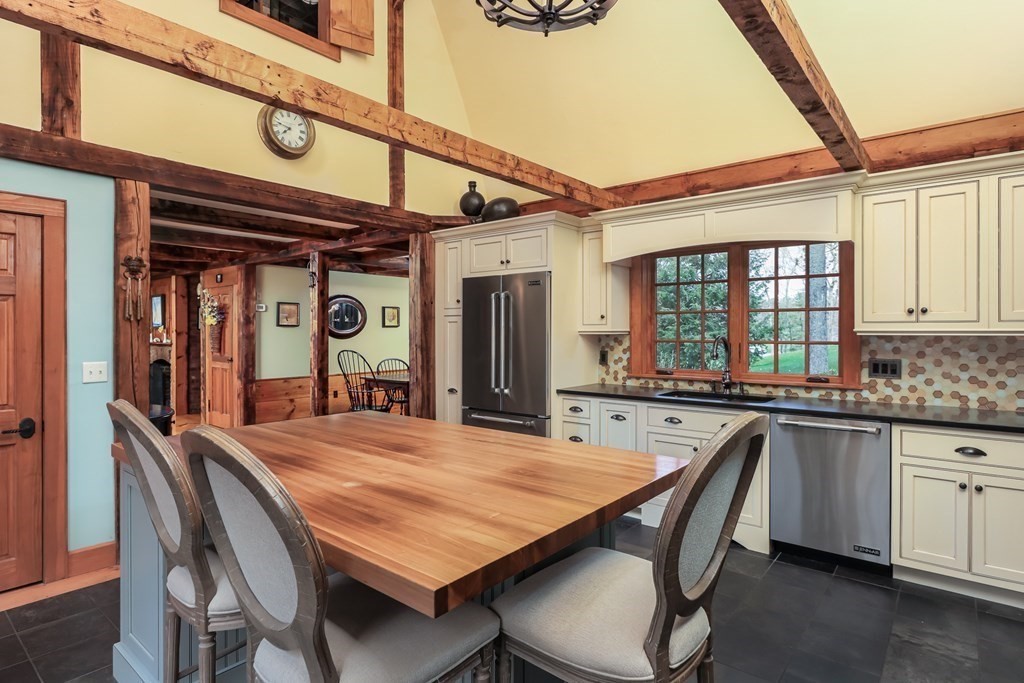 24 Whitney Road Shirley, MA 01464 - Photo 4 of 42 a dining table with chairs and cabinets