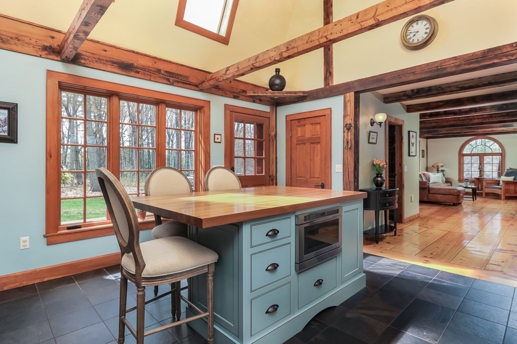 24 Whitney Road Shirley, MA 01464 - Photo 5 of 42 a dining hall with stainless steel appliances granite countertop a stove and cabinets with wooden floor