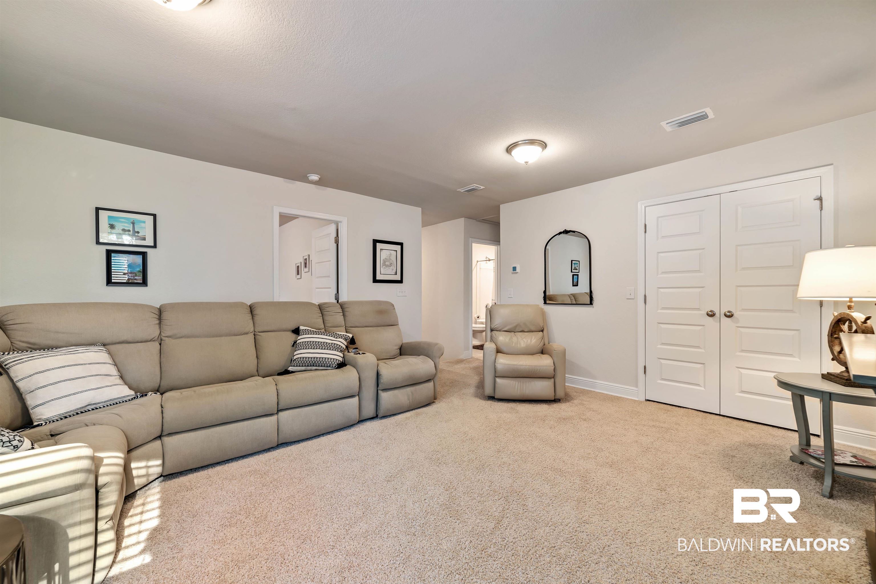 1290 Mako Loop Gulf Shores, AL 36542 - Photo 23 of 50 Carpeted living area with visible vents and baseboards