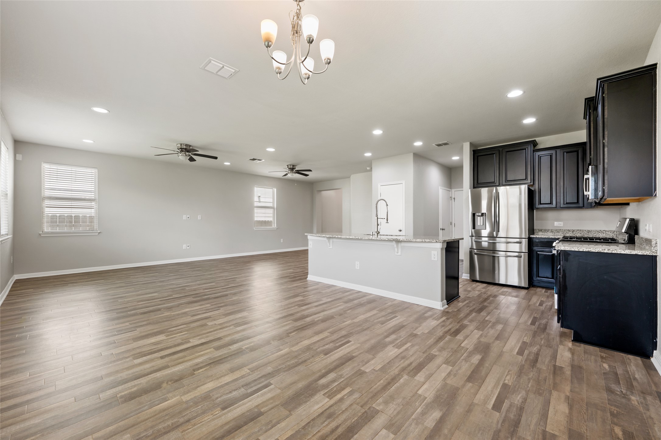 124 Guemal Road Buda, TX 78610 - Photo 12 of 40 An open-concept living space integrates a well-appointed kitchen with an island, ideal for entertaining.