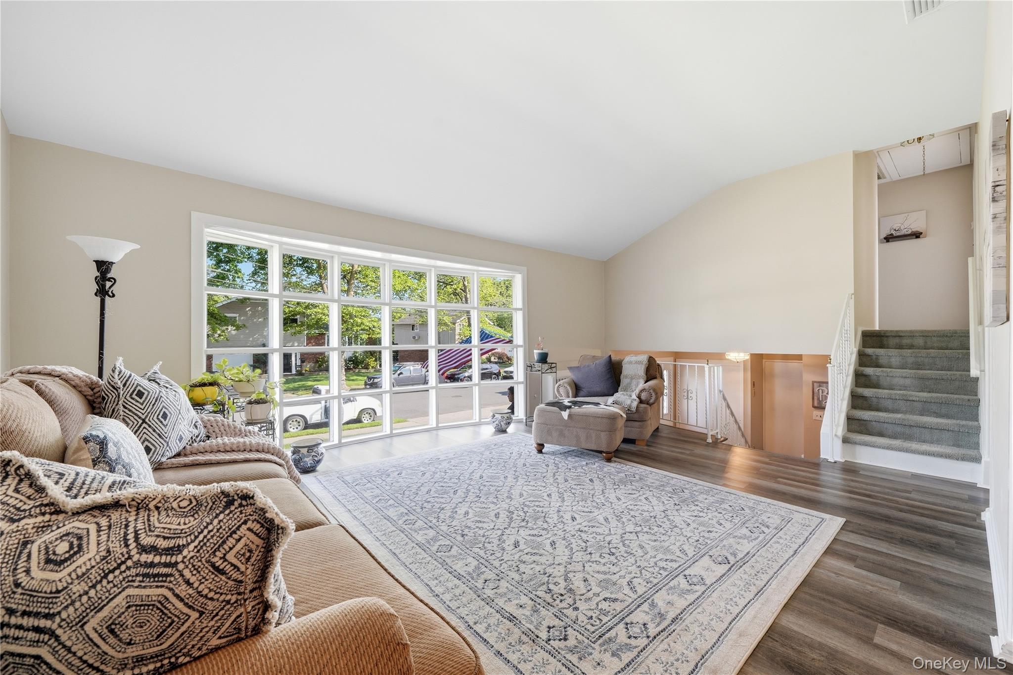 1853 Decatur Avenue Merrick, NY 11566 - Photo 8 of 43 a living room with furniture rug and a table