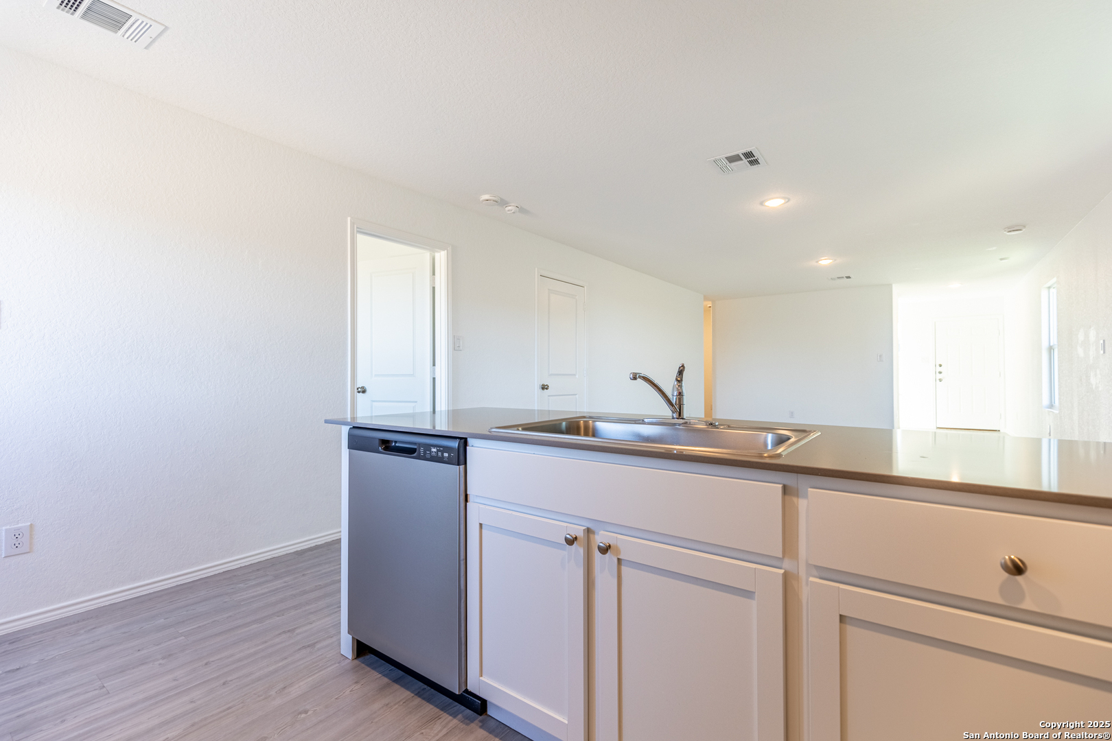 9143 Coronal Rings San Antonio, TX 78252 - Photo 11 of 30 a kitchen with granite countertop white cabinets and a sink
