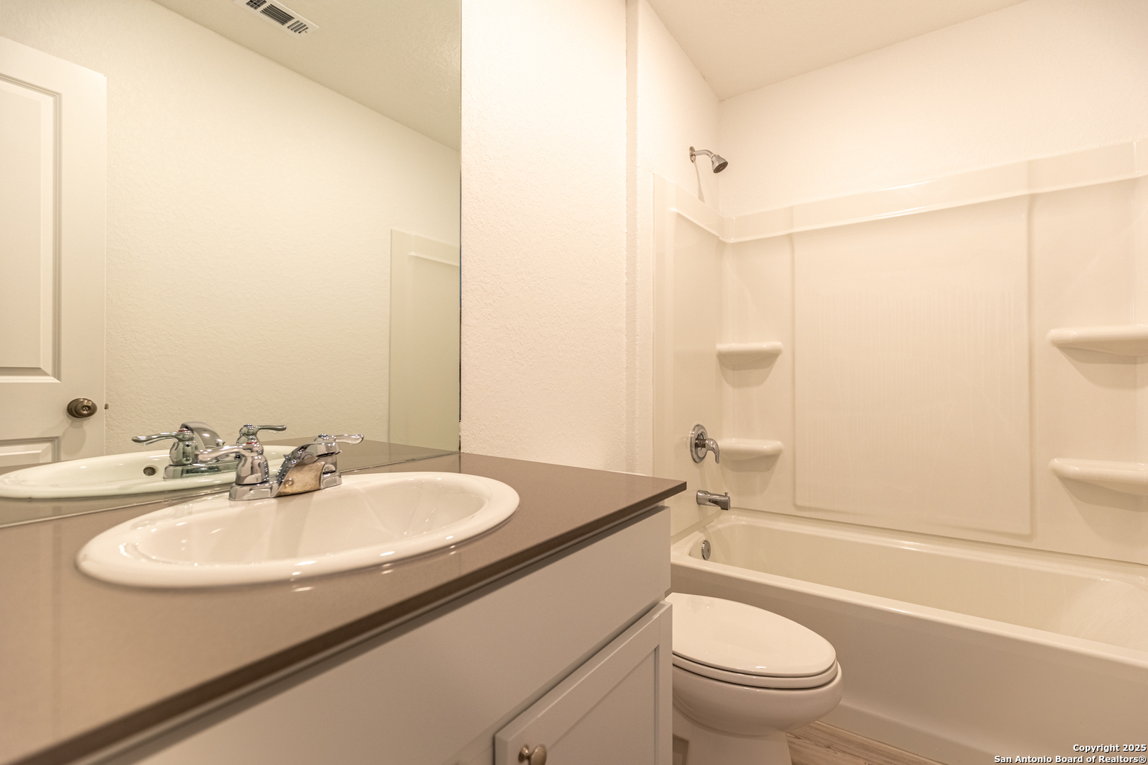 9143 Coronal Rings San Antonio, TX 78252 - Photo 15 of 30 a bathroom with a sink toilet and shower
