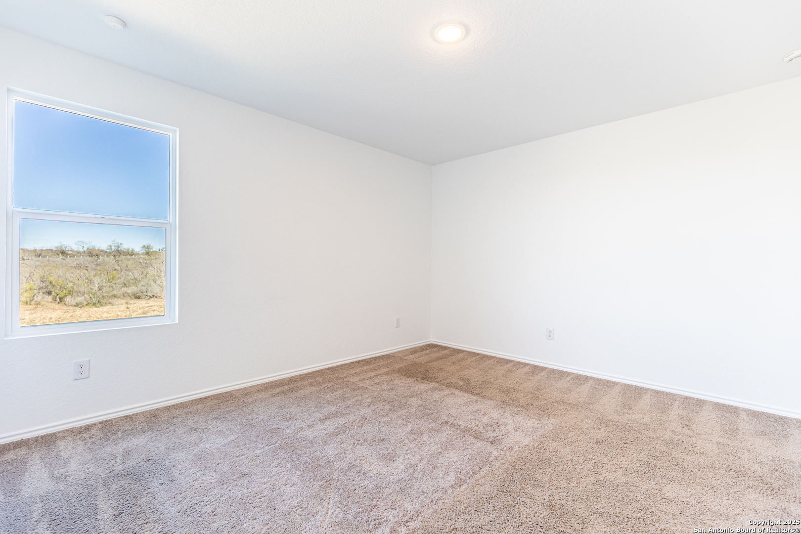 9143 Coronal Rings San Antonio, TX 78252 - Photo 18 of 30 an empty room with a window
