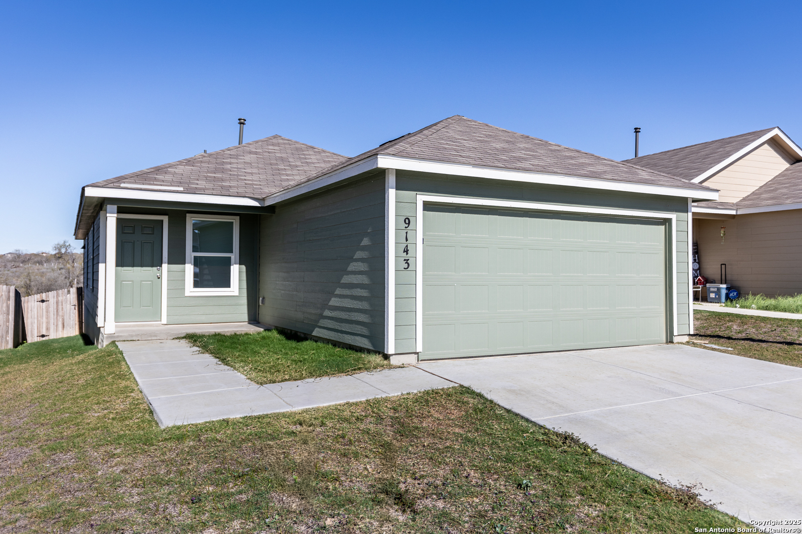9143 Coronal Rings San Antonio, TX 78252 - Photo 2 of 30 a front view of a house with a yard and garage