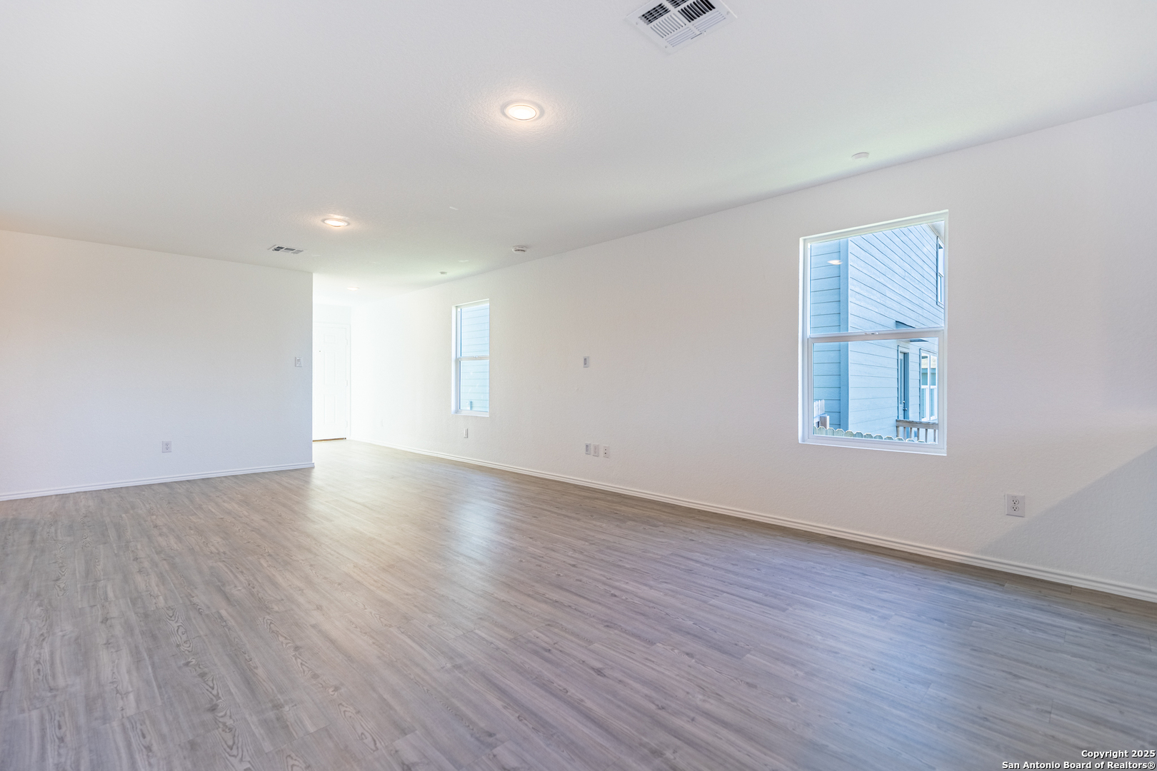 9143 Coronal Rings San Antonio, TX 78252 - Photo 6 of 30 an empty room with wooden floor and windows