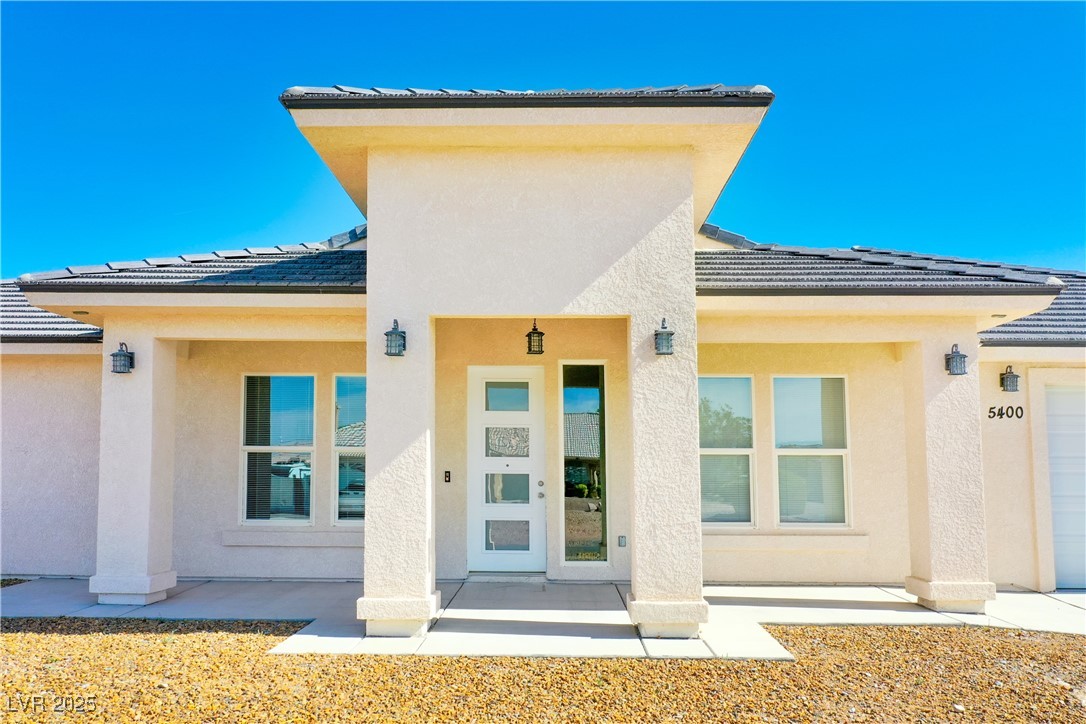 5400 Grain Mill Road Pahrump, NV 89061 - Photo 2 of 67 Property entrance featuring stucco siding and a tiled roof