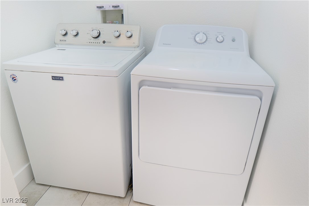 5400 Grain Mill Road Pahrump, NV 89061 - Photo 23 of 67 Clothes washing area featuring washer and dryer and light tile patterned floors