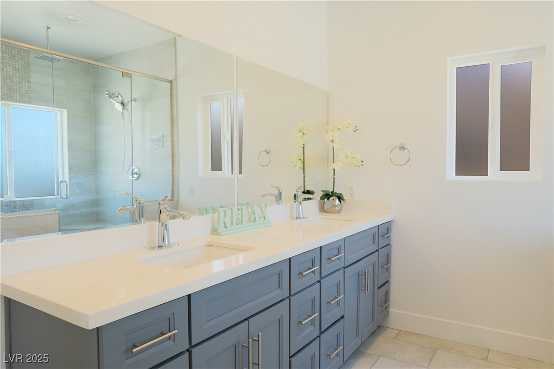 5400 Grain Mill Road Pahrump, NV 89061 - Photo 29 of 67 Full bath featuring a shower stall, tile patterned flooring, baseboards, and double vanity
