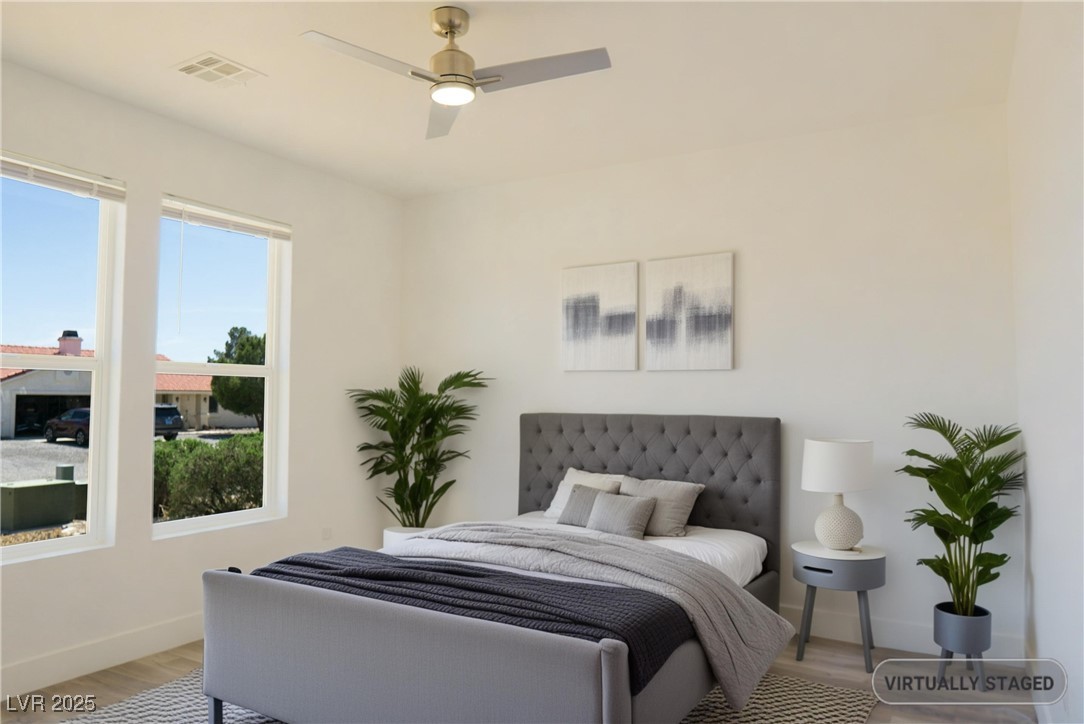 5400 Grain Mill Road Pahrump, NV 89061 - Photo 37 of 67 Bedroom featuring light wood-style flooring, multiple windows, baseboards, and a ceiling fan
