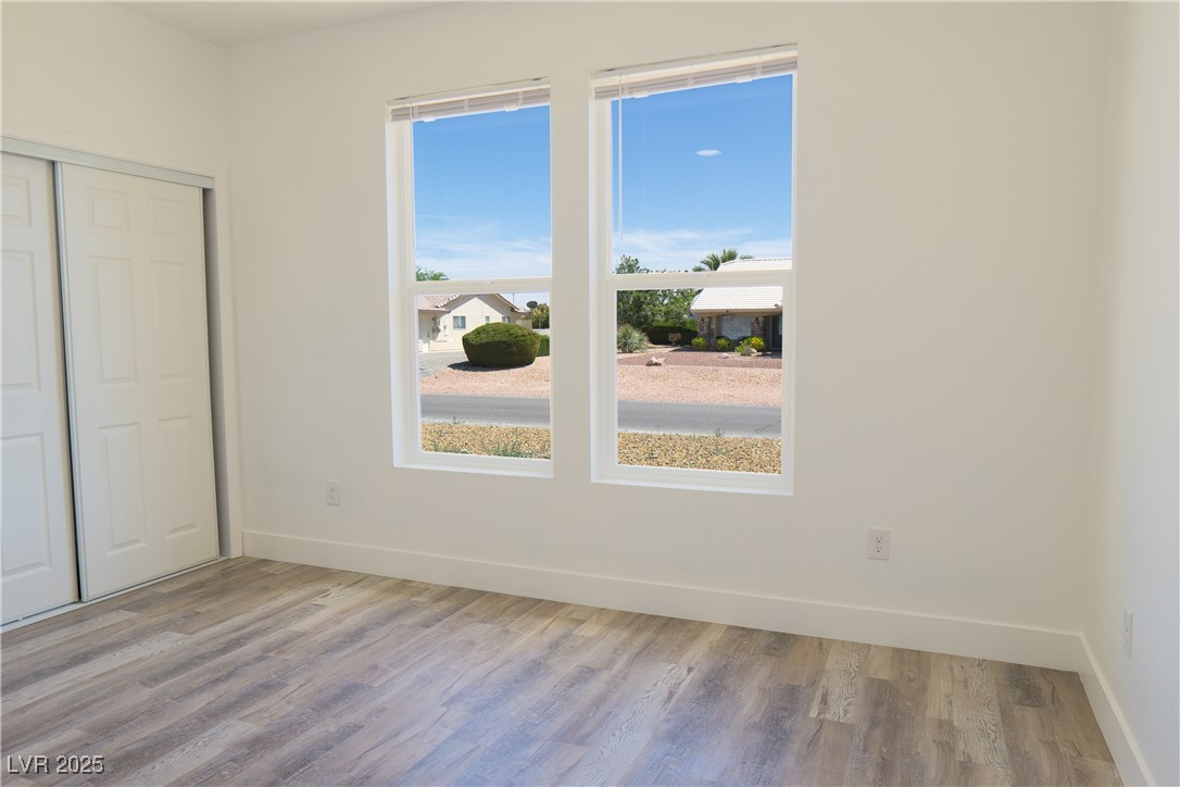 5400 Grain Mill Road Pahrump, NV 89061 - Photo 38 of 67 Unfurnished bedroom featuring baseboards, wood finished floors, and a closet