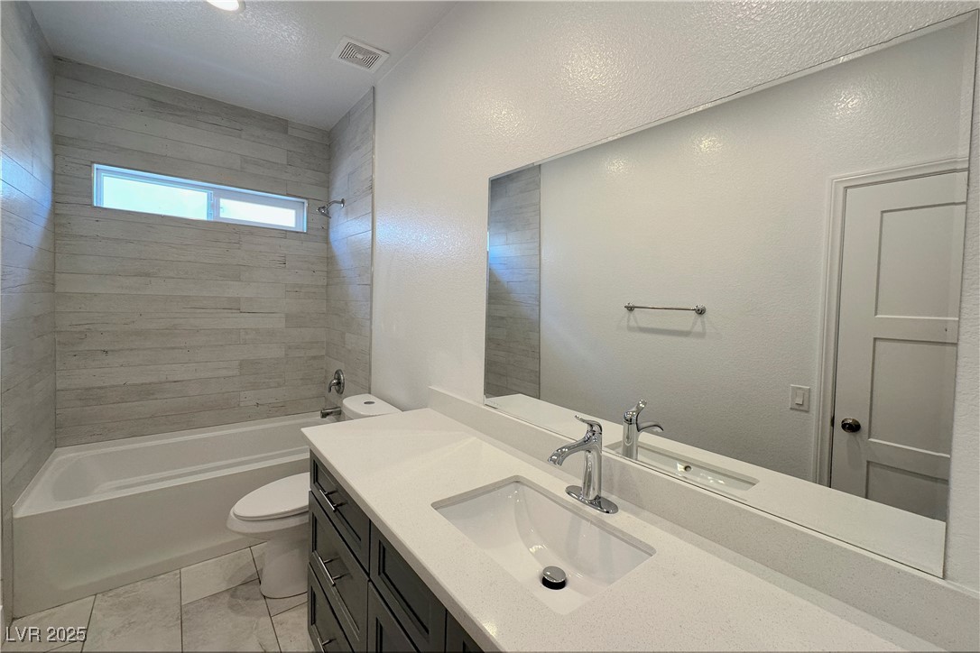 5400 Grain Mill Road Pahrump, NV 89061 - Photo 40 of 67 Full bathroom featuring toilet, tub / shower combination, vanity, and marble finish flooring
