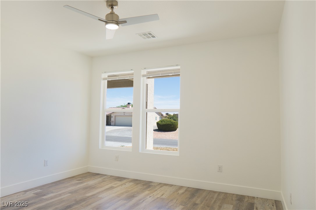 5400 Grain Mill Road Pahrump, NV 89061 - Photo 43 of 67 Unfurnished room featuring baseboards, light wood finished floors, and a ceiling fan