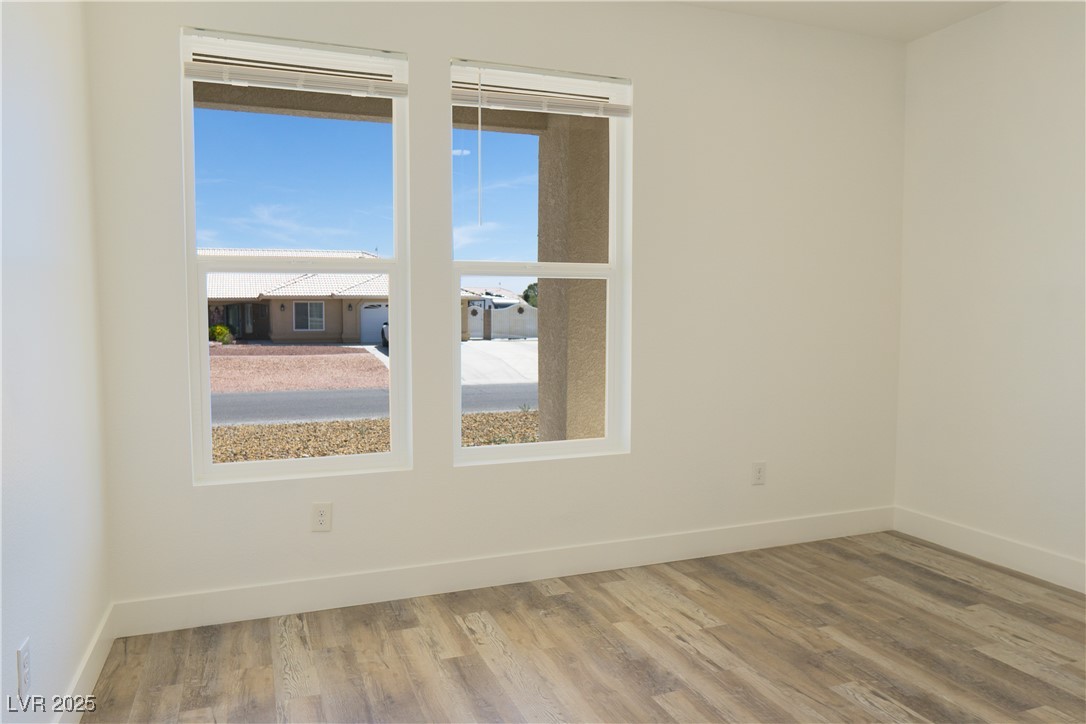 5400 Grain Mill Road Pahrump, NV 89061 - Photo 45 of 67 Empty room featuring wood finished floors and baseboards