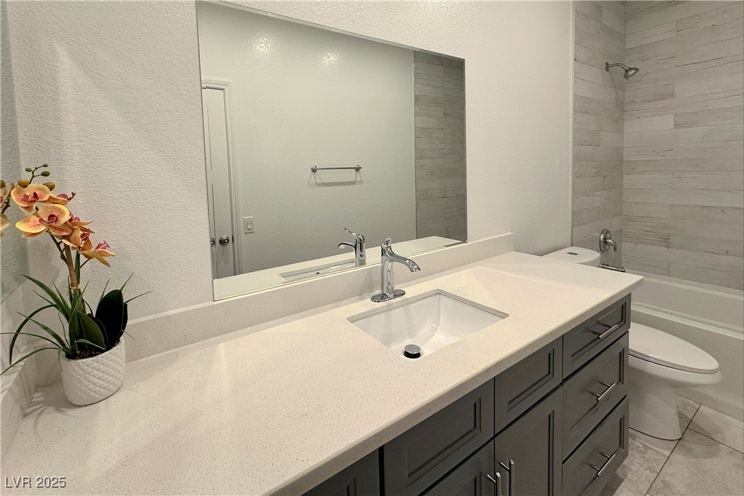 5400 Grain Mill Road Pahrump, NV 89061 - Photo 46 of 67 Full bath featuring toilet, bathing tub / shower combination, vanity, and a textured wall