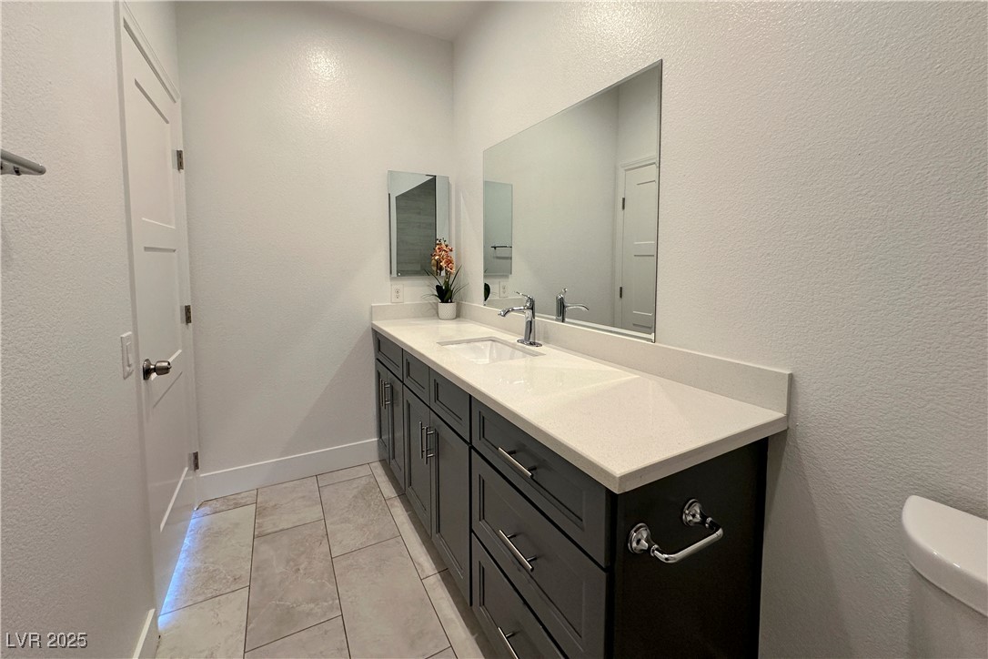 5400 Grain Mill Road Pahrump, NV 89061 - Photo 47 of 67 Bathroom featuring vanity, toilet, and baseboards
