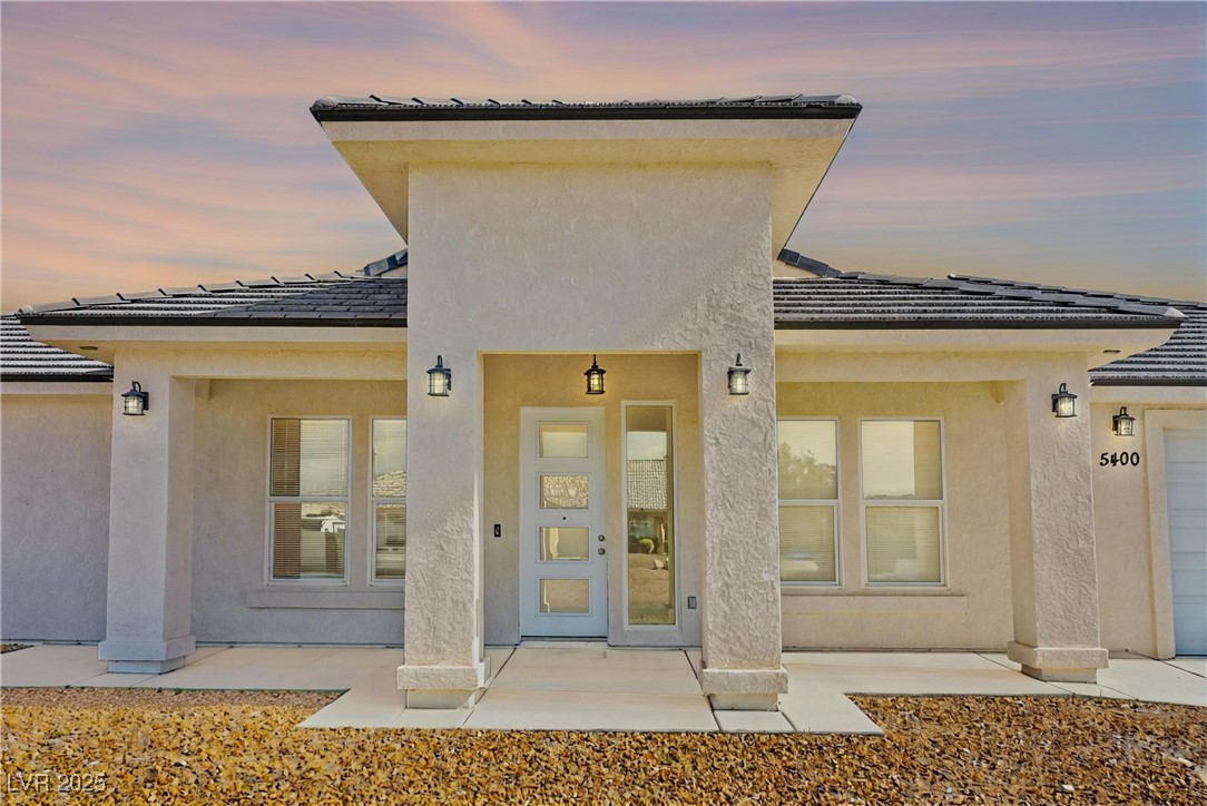 5400 Grain Mill Road Pahrump, NV 89061 - Photo 58 of 67 Exterior entry at dusk featuring stucco siding