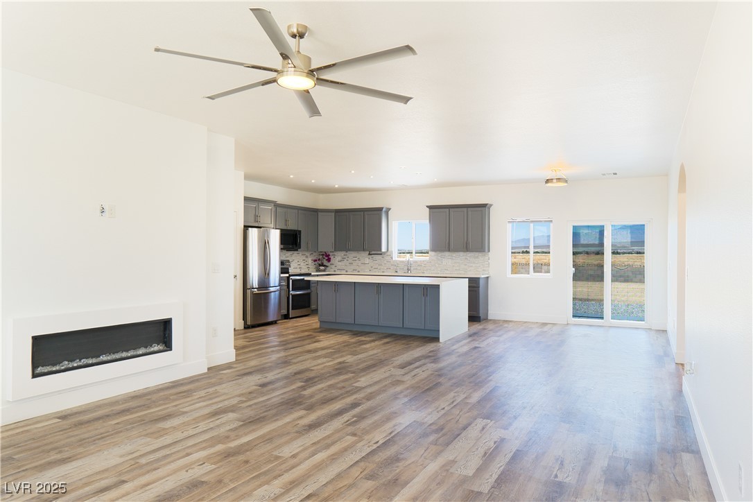 5400 Grain Mill Road Pahrump, NV 89061 - Photo 66 of 67 Kitchen featuring appliances with stainless steel finishes, open floor plan, gray cabinetry, and light countertops