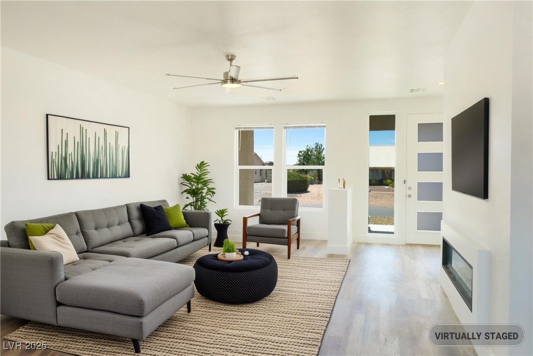 5400 Grain Mill Road Pahrump, NV 89061 - Photo 7 of 67 Living room with wood finished floors, ceiling fan, and baseboards