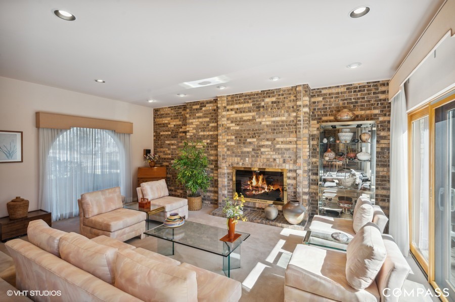 1119 Deerfield Road Deerfield, IL 60015 - Photo 4 of 19 a living room with fireplace furniture and a floor to ceiling window