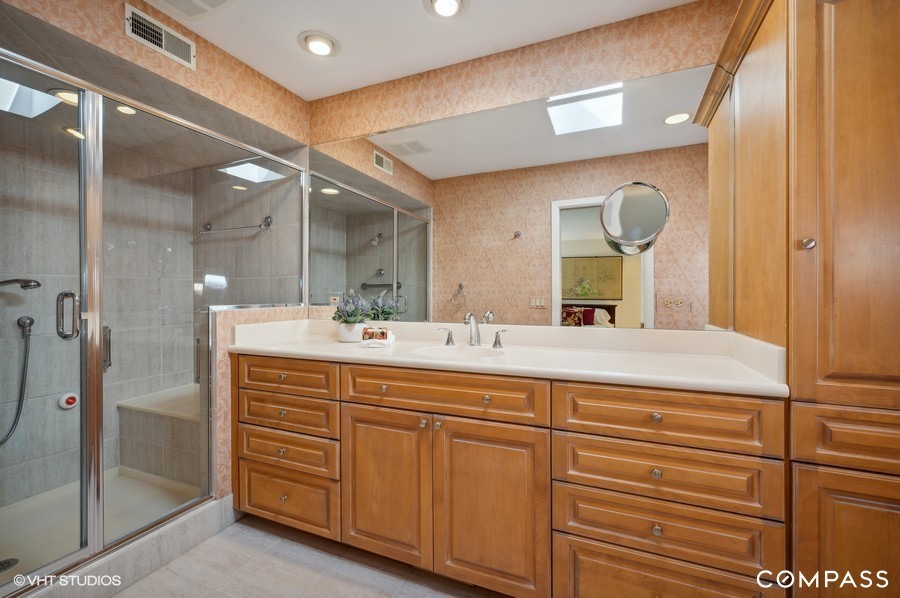 1119 Deerfield Road Deerfield, IL 60015 - Photo 10 of 19 a bathroom with a double vanity sink and a mirror