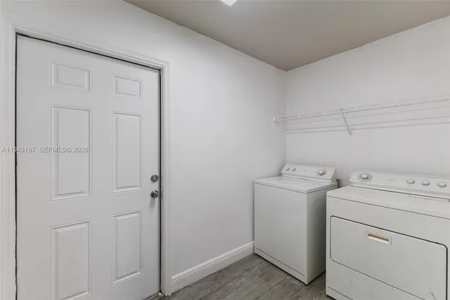 a view of storage and utility room with washer and dryer