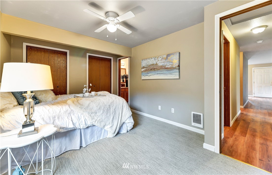 5529 Lowell Road Everett, WA 98203 - Photo 13 of 22 a bedroom with a large bed and a chandelier