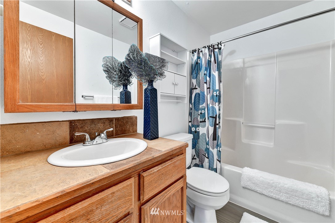5529 Lowell Road Everett, WA 98203 - Photo 14 of 22 a bathroom with a sink a toilet and shower
