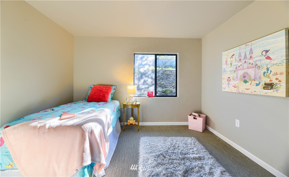 5529 Lowell Road Everett, WA 98203 - Photo 15 of 22 a bedroom with a bed and a painting on the wall