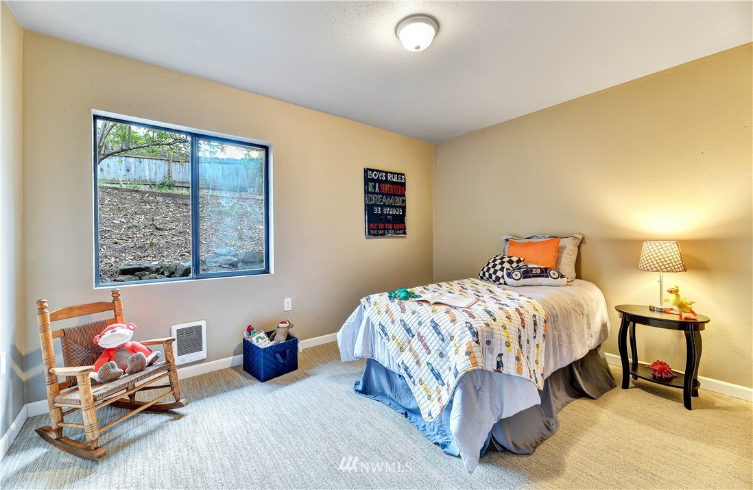 5529 Lowell Road Everett, WA 98203 - Photo 16 of 22 a bedroom with a bed and wooden floor