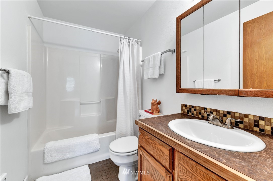 5529 Lowell Road Everett, WA 98203 - Photo 18 of 22 a bathroom with a sink a toilet and shower