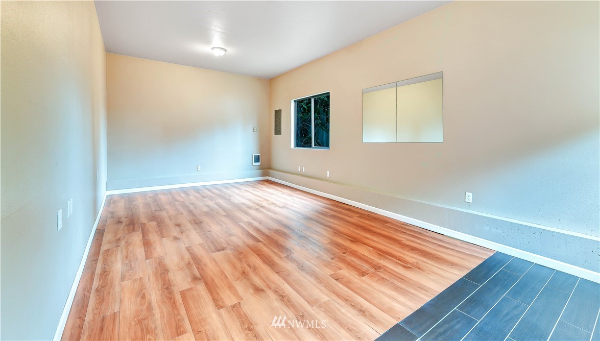 5529 Lowell Road Everett, WA 98203 - Photo 19 of 22 a view of a room with wooden floor and brick walls