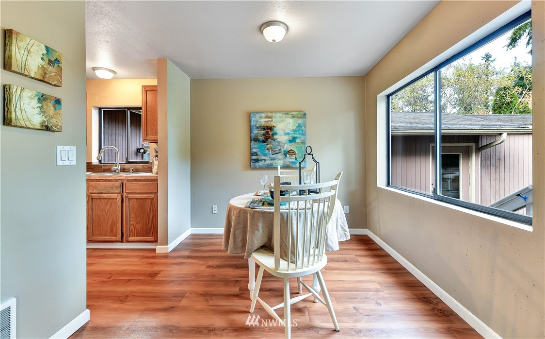 5529 Lowell Road Everett, WA 98203 - Photo 8 of 22 a dining room with wooden floor and a window