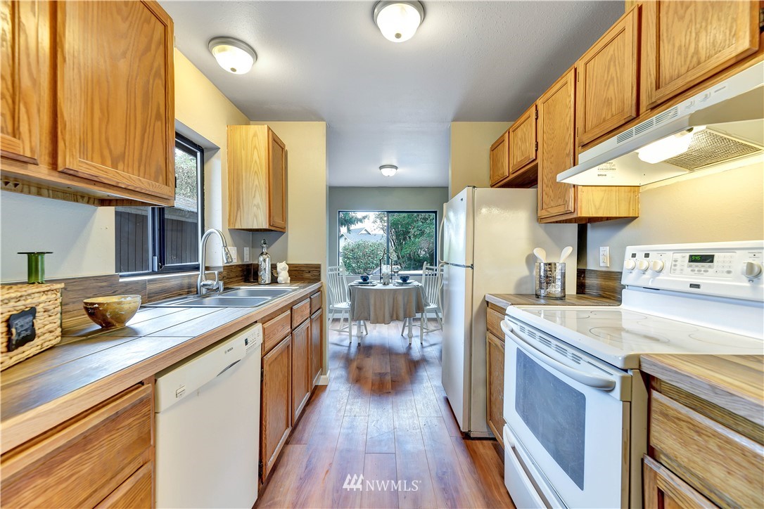 5529 Lowell Road Everett, WA 98203 - Photo 10 of 22 a kitchen with stainless steel appliances granite countertop a lot of counter space and wooden floors