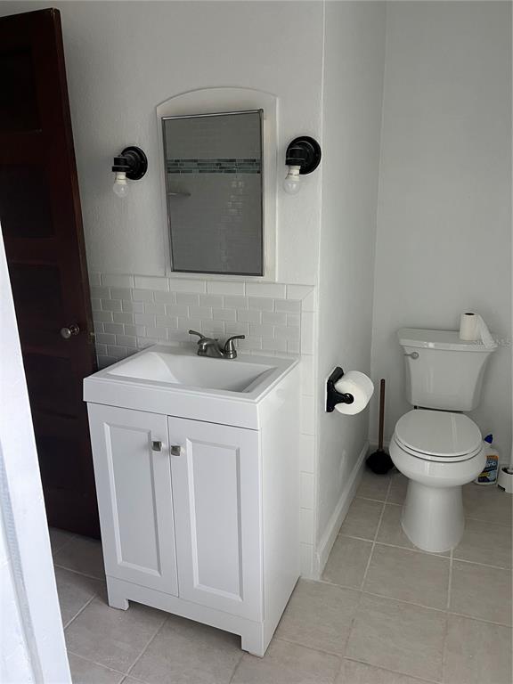 302 West Wall Street Frostproof, FL 33843 - Photo 13 of 37 a bathroom with a sink toilet and mirror
