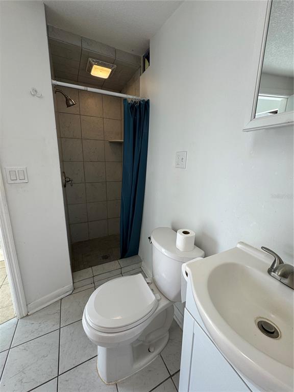 302 West Wall Street Frostproof, FL 33843 - Photo 18 of 37 a white toilet sitting next to a bathroom sink