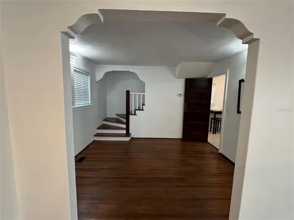a view of a hallway view with wooden floor and staircase