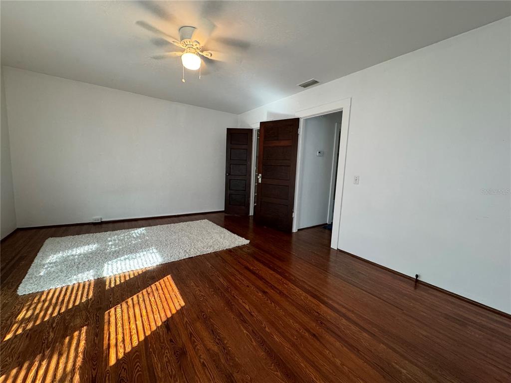 302 West Wall Street Frostproof, FL 33843 - Photo 32 of 37 wooden floor in an empty room with a window