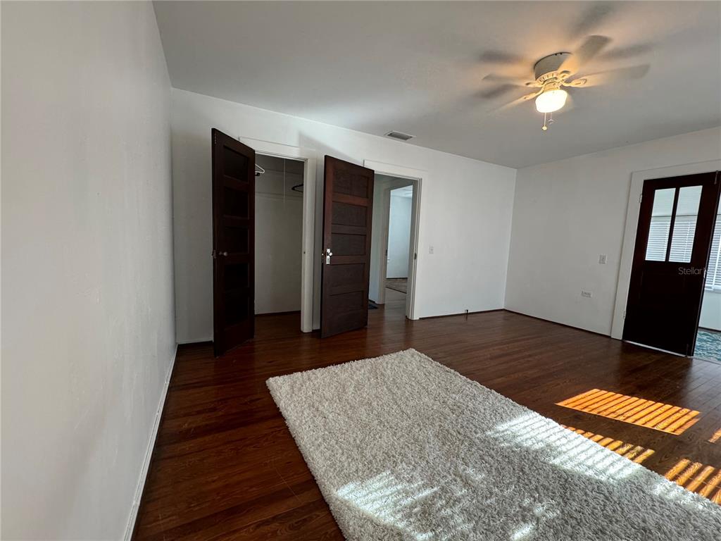 302 West Wall Street Frostproof, FL 33843 - Photo 33 of 37 a bedroom with a bed and a chandelier