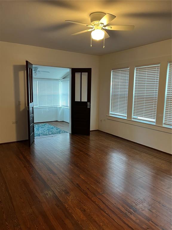 302 West Wall Street Frostproof, FL 33843 - Photo 4 of 37 a view of an empty room with wooden floor and a window