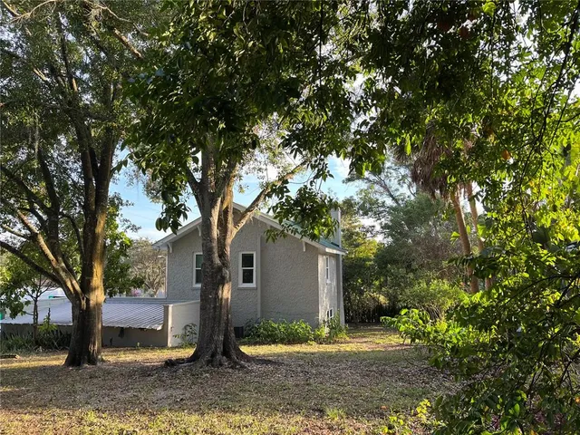 a view of a house with a tree in the background
