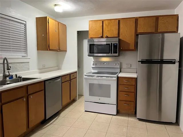 a kitchen with a refrigerator sink and microwave