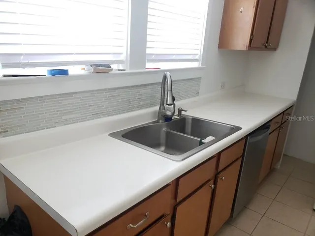 a kitchen with a sink and a window