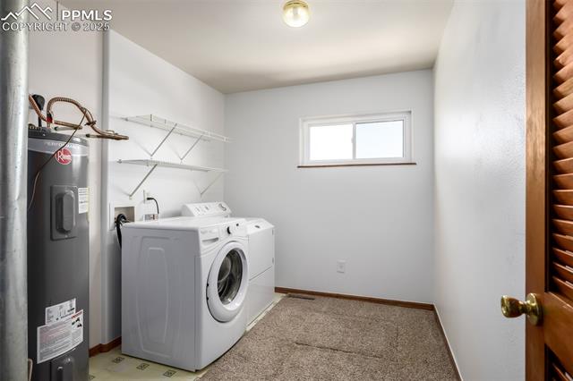 6065 Mulberry Road Calhan, CO 80808 - Photo 20 of 45 Washroom with electric water heater, washing machine and clothes dryer, and light colored carpet