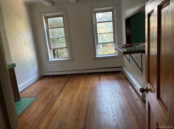 wooden floor in an empty room with a window
