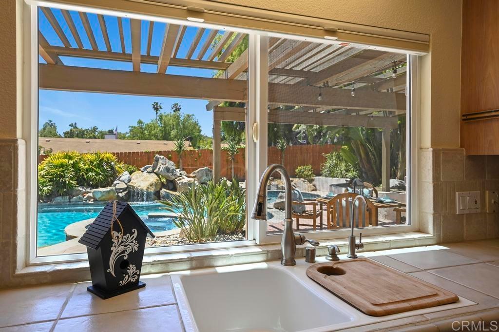 546 Rancho Santa Fe Road Encinitas, CA 92024 - Photo 12 of 48 a living room with a floor to ceiling window and a floor to ceiling window