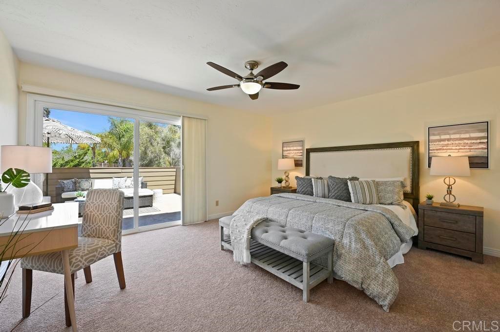 546 Rancho Santa Fe Road Encinitas, CA 92024 - Photo 25 of 48 a bedroom with a bed and a chandelier