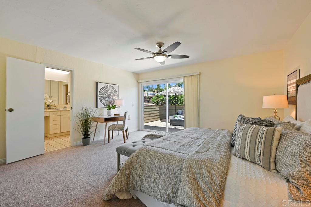 546 Rancho Santa Fe Road Encinitas, CA 92024 - Photo 26 of 48 a spacious bedroom with a bed and a chandelier