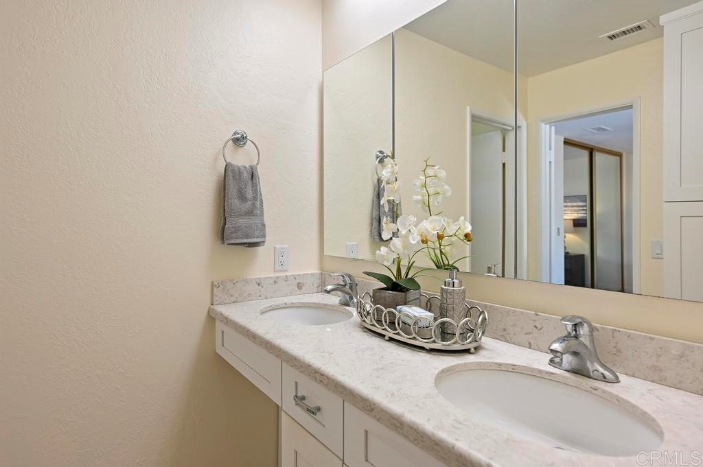 546 Rancho Santa Fe Road Encinitas, CA 92024 - Photo 29 of 48 a bathroom with double vanity sinks and a mirror